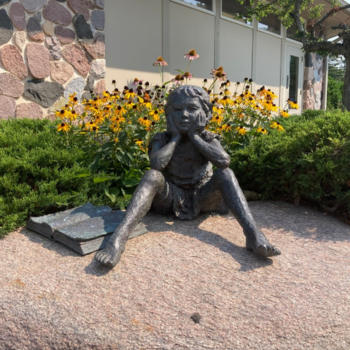 Statue of little girl in front of the library 